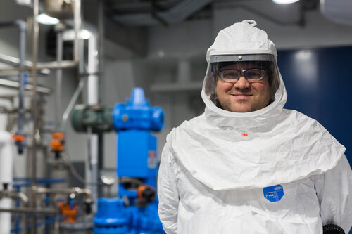 Portrait of Chattem Chemicals Employee in Tyvek suit